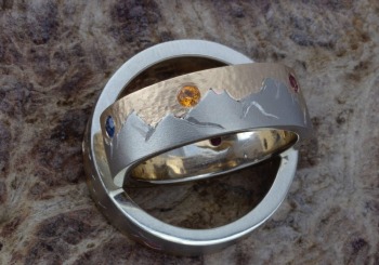 an intricate Fancy Montana Sapphire mountain range ring set.